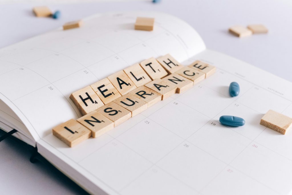 Health insurance scrabble tiles on planner