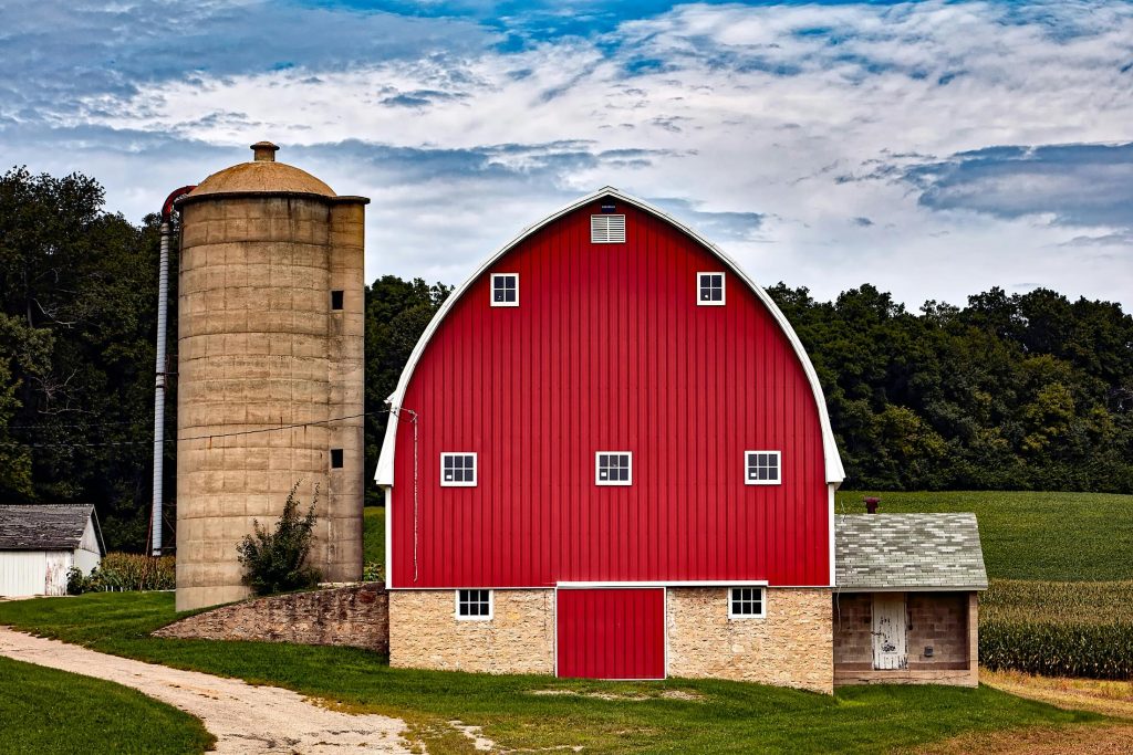 Red barn and silo on farm