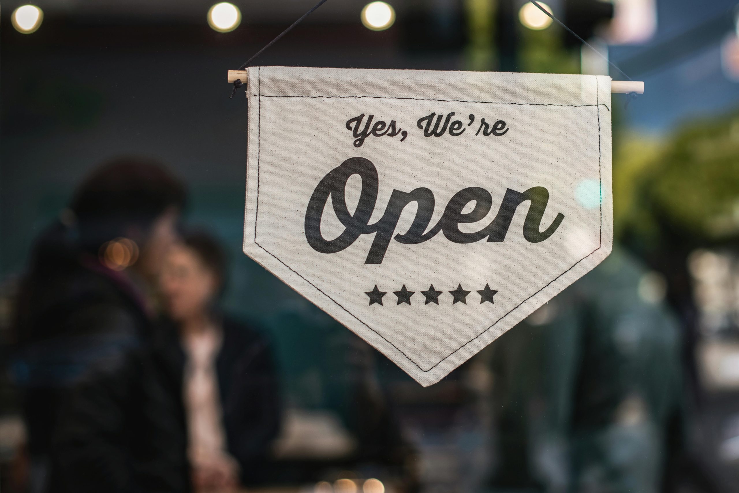 Open sign hanging in a window